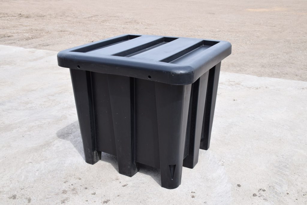 black plastic tote container sitting on cement